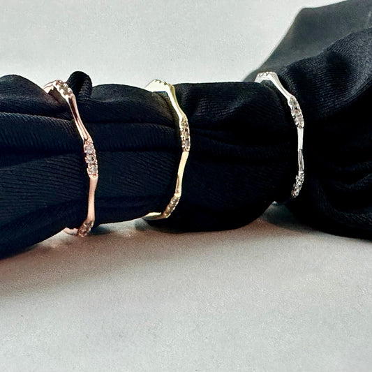 Three rings on a black fabric background