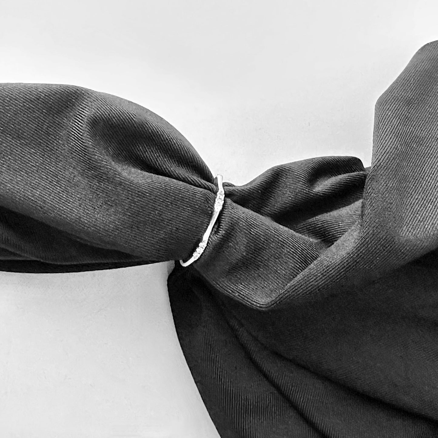 Dark gray fabric with a knot on a white background