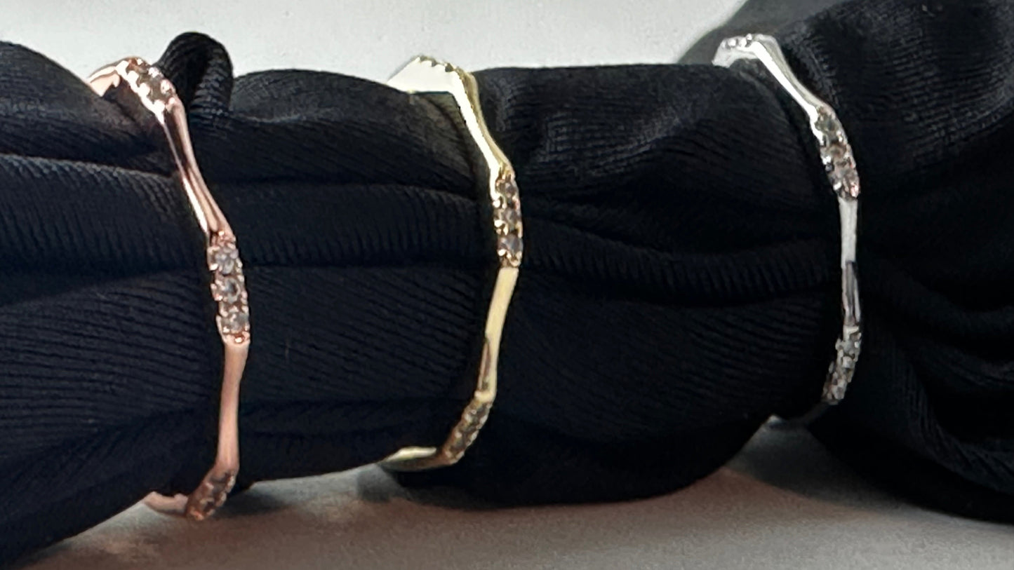 Black ribbons with gold and silver decorative loops on a light gray background