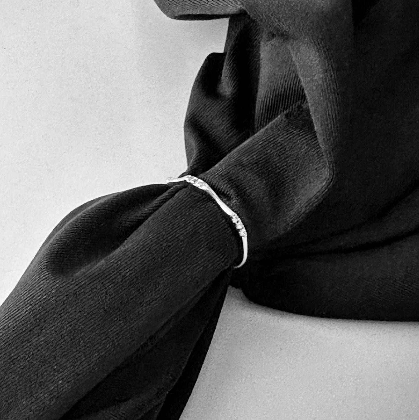 black fabric with simple silver band with CZ