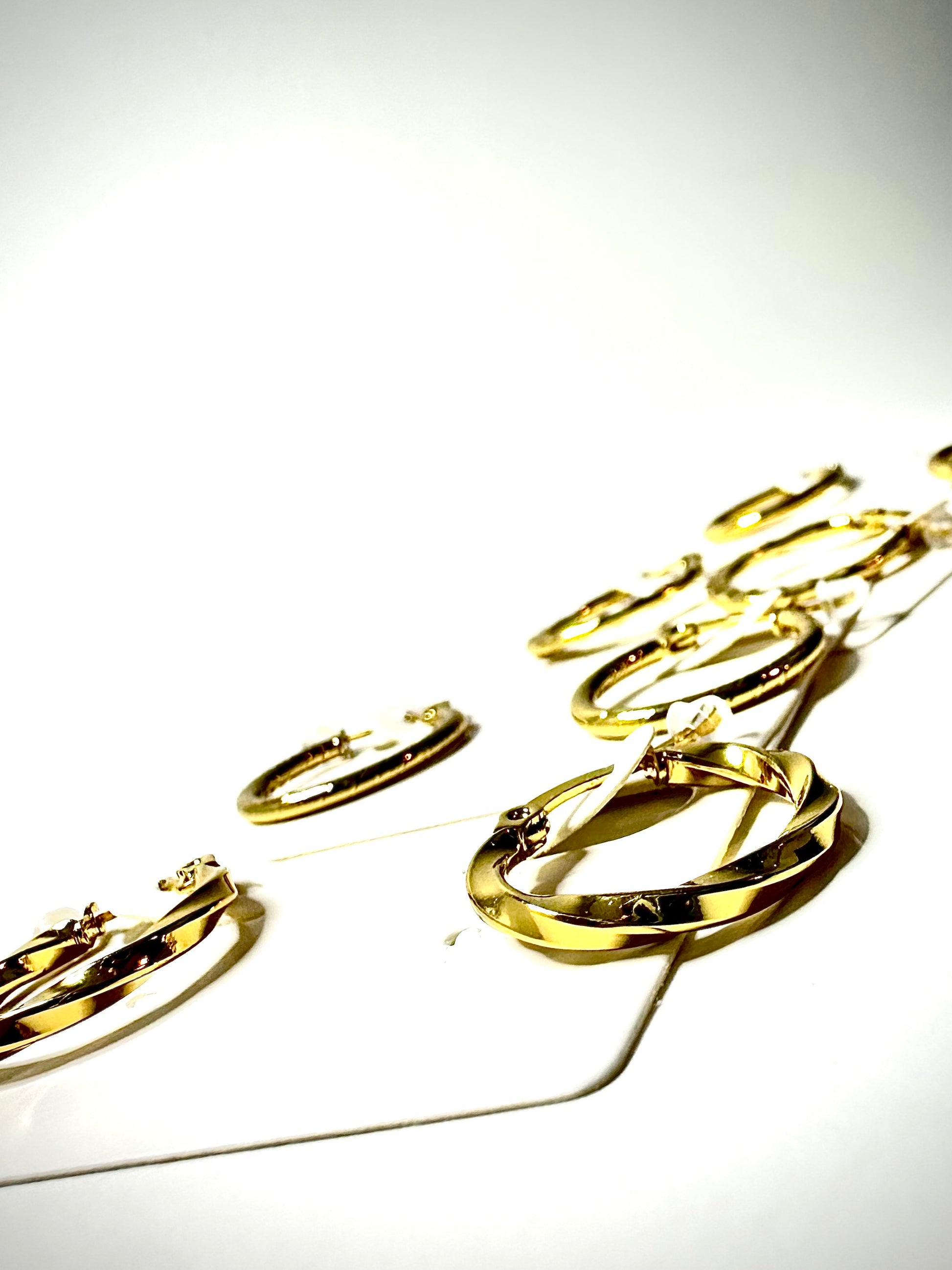 Gold hoop earrings on a white background