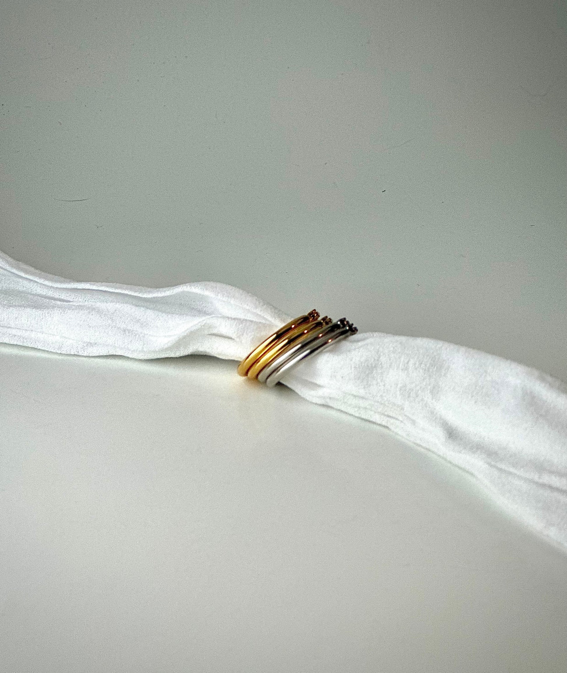 earrings on a white fabric against a gray background - Style A