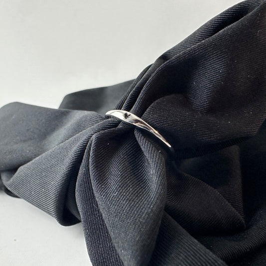 Black fabric with a silver ring on a white background